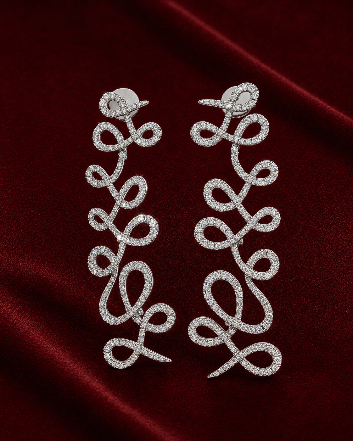 Campaign image featuring EED1815 diamond loop earrings on ERS4997 burgundy velvet scene