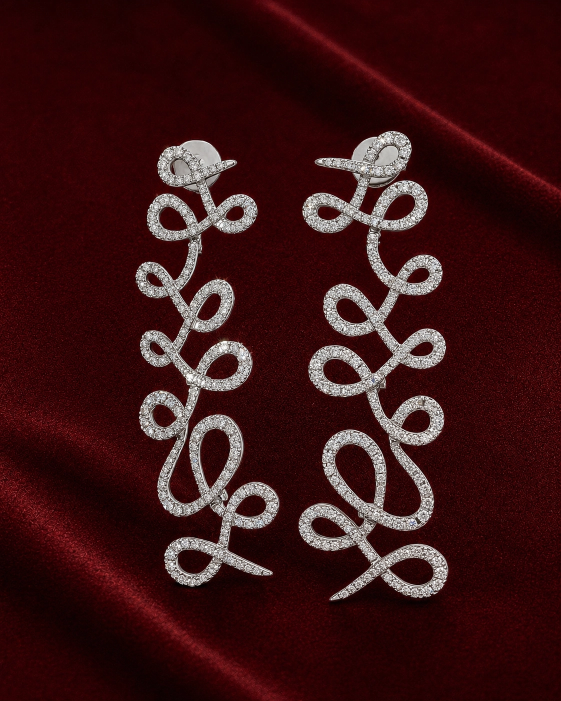 Campaign image featuring EED1815 diamond loop earrings on ERS4997 burgundy velvet scene