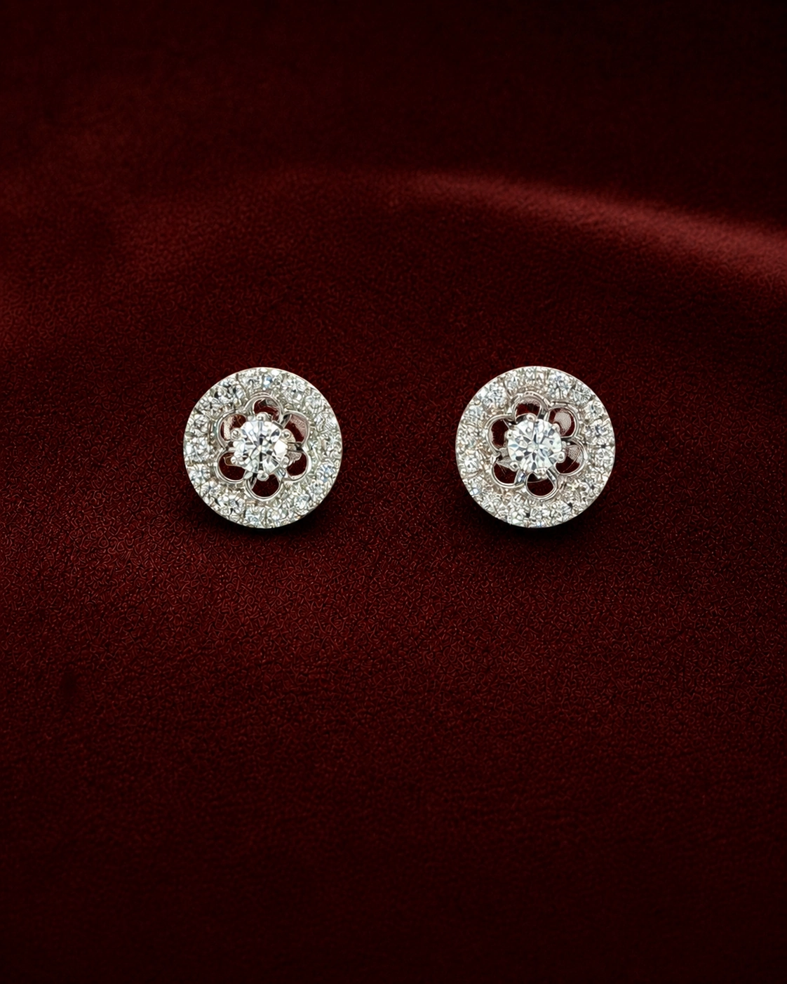 EES2173 floral halo diamond stud earrings on deep burgundy velvet