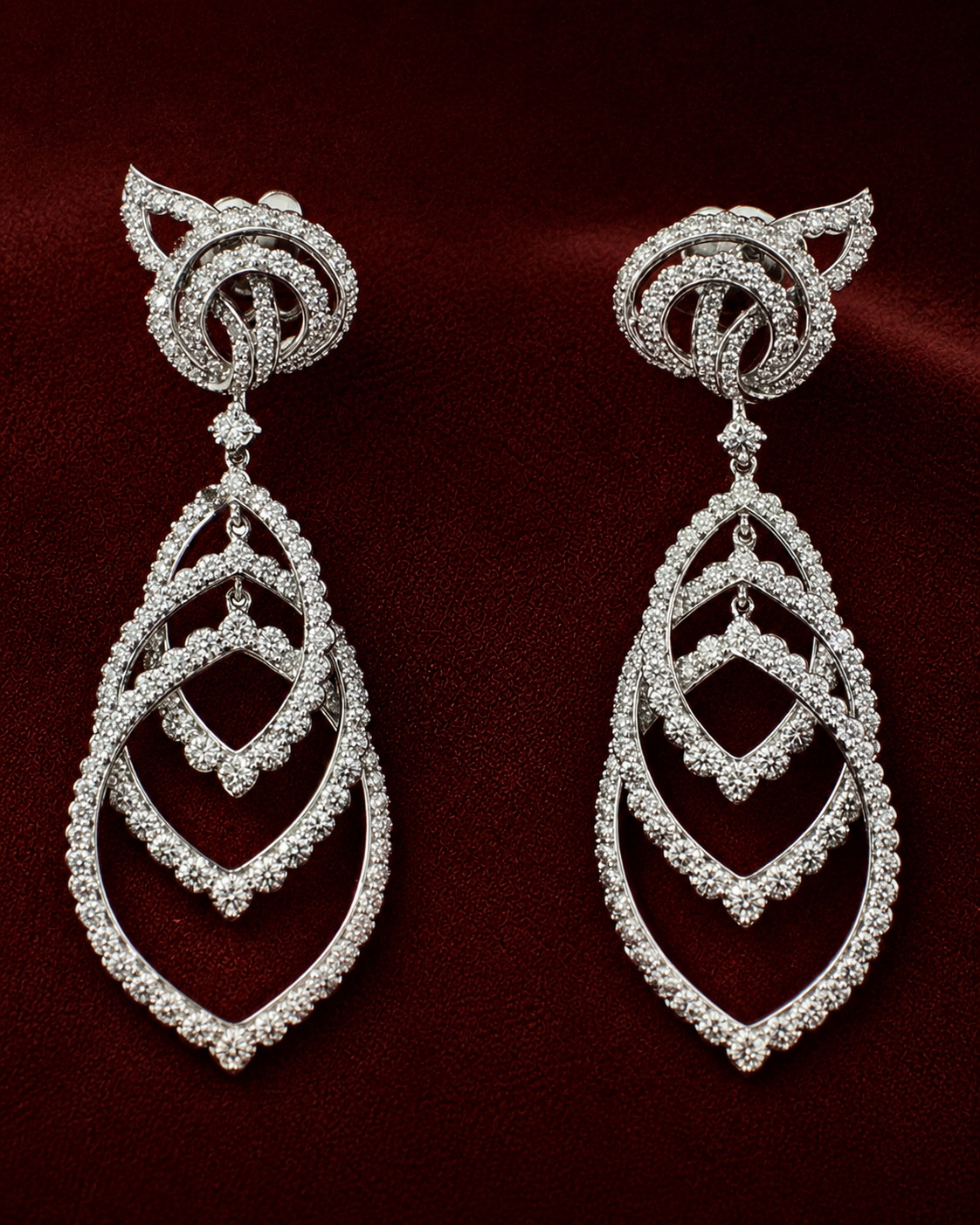 EES5821 interlocking teardrop diamond earrings on the Scene 1 deep red velvet background