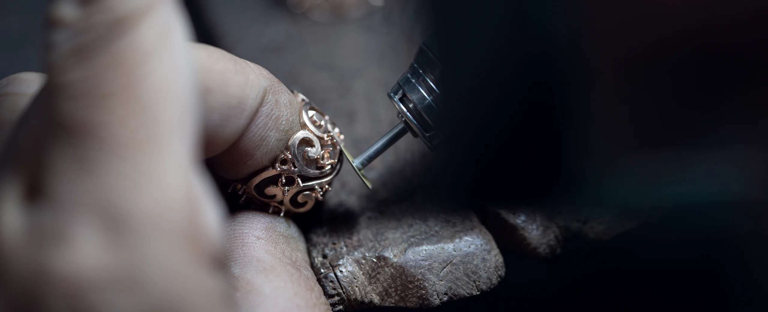 ThienPo artisan refining a gold jewelry component by hand.